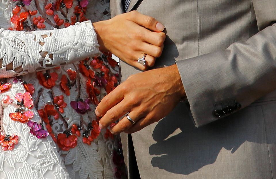 Wedding rings are seen on the hands of U.S. actor George Clooney (R) and his wife Amal Alamuddin