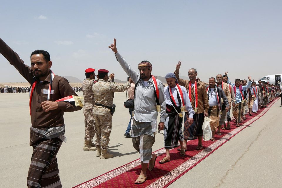 Prisoners leave a plane chartered by the Red Cross at Yemen’s Marib Airport, amid a swap between two sides in the country's conflict. Photo: Ali Owidha/Reuters