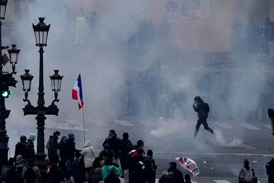 Protesters scuffle at the end of a rally in Paris on Thursday (Christophe Ena/AP)