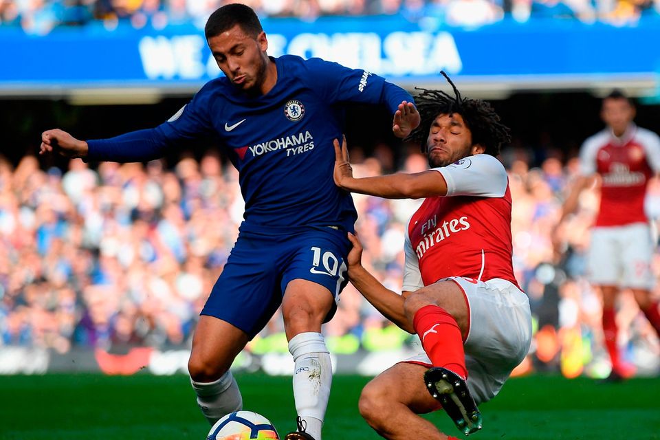 Chelsea’s Eden Hazard is tackled by Arsenal’s Mohamed Elneny during the Premier League match at Stamford Bridge. Photo by Mike Hewitt/Getty Images