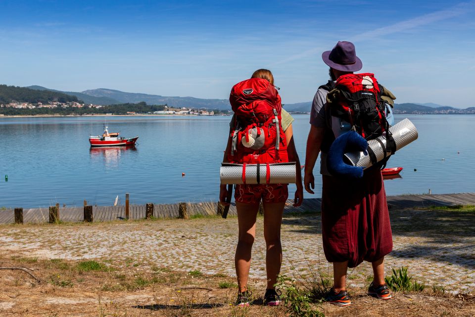 Two pilgrims look at the Miño river in Caminha, Portugal. Photo by Xurxo Lobato/Getty Images