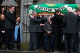 thumbnail: Niall Quinn, (son) and his mother, Mary, (wife), follow as the coffin is carried from St Marys Church, Killenaule, Co. Tipperary after the funeral of Billy Quinn