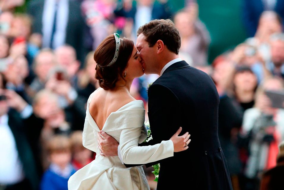 Princess Eugenie and her new husband Jack Brooksbank kiss as they leave St George's Chapel in Windsor Castle following their wedding