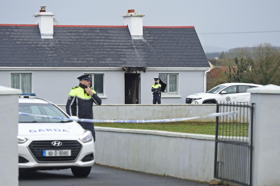Gardaí attend the scene of the house fire in Pheasanthill, Castlebar, Co Mayo after the discovery of John Brogan's body. Photo: Conor McKeown