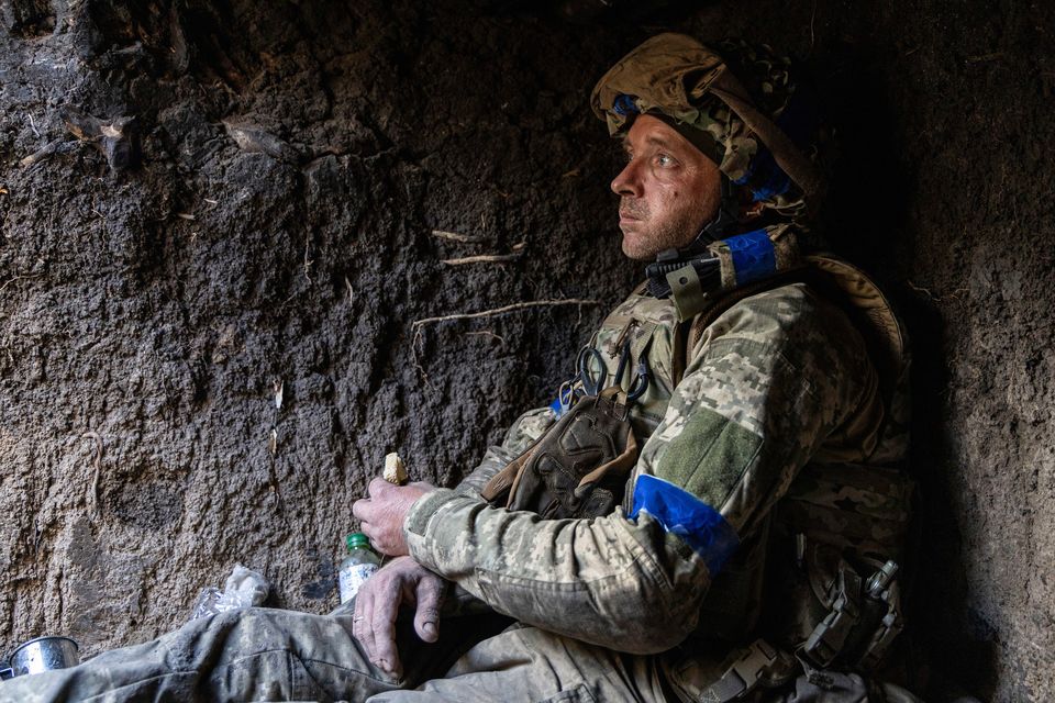 A Ukrainian serviceman from the 3rd Assault Brigade eats a piece of bread in a trench on his position at the frontline a few kilometres from Andriivka, Donetsk region, Ukraine. Photo: AP