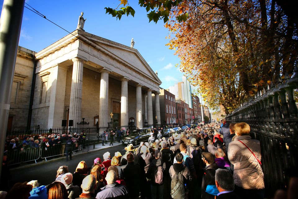 Crowds gather outside the Pro Cathedral for the funeral of Gay Byrne.
