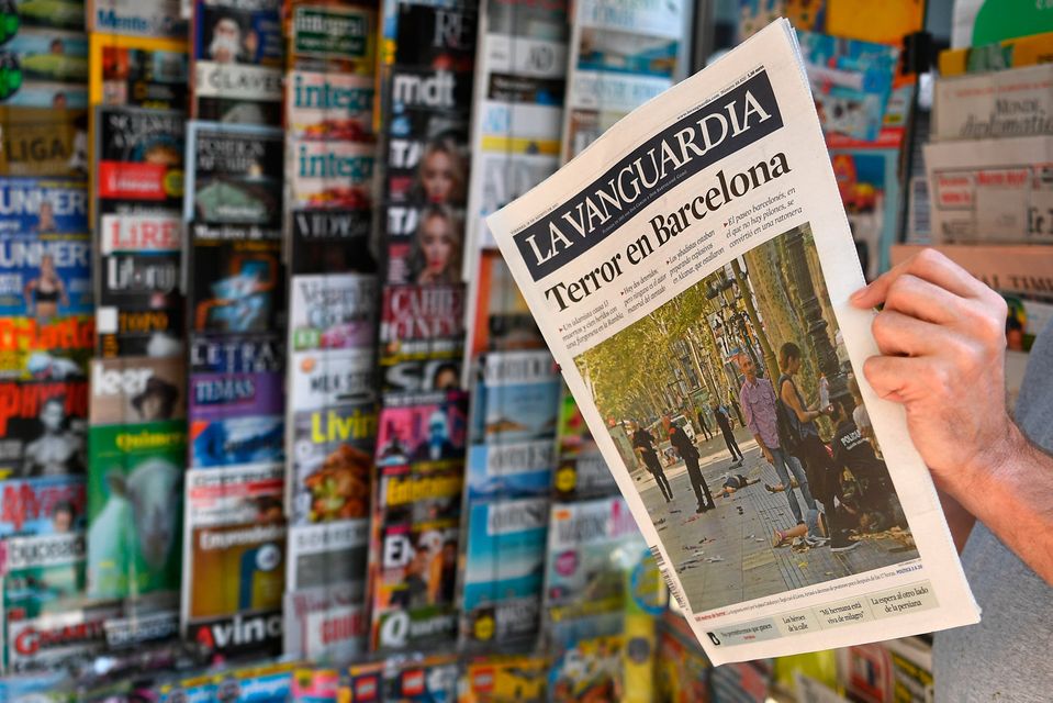 A person reads the Catalan newspaper La Vanguardia on August 18. Photo - GABRIEL BOUYS/AFP/Getty Images