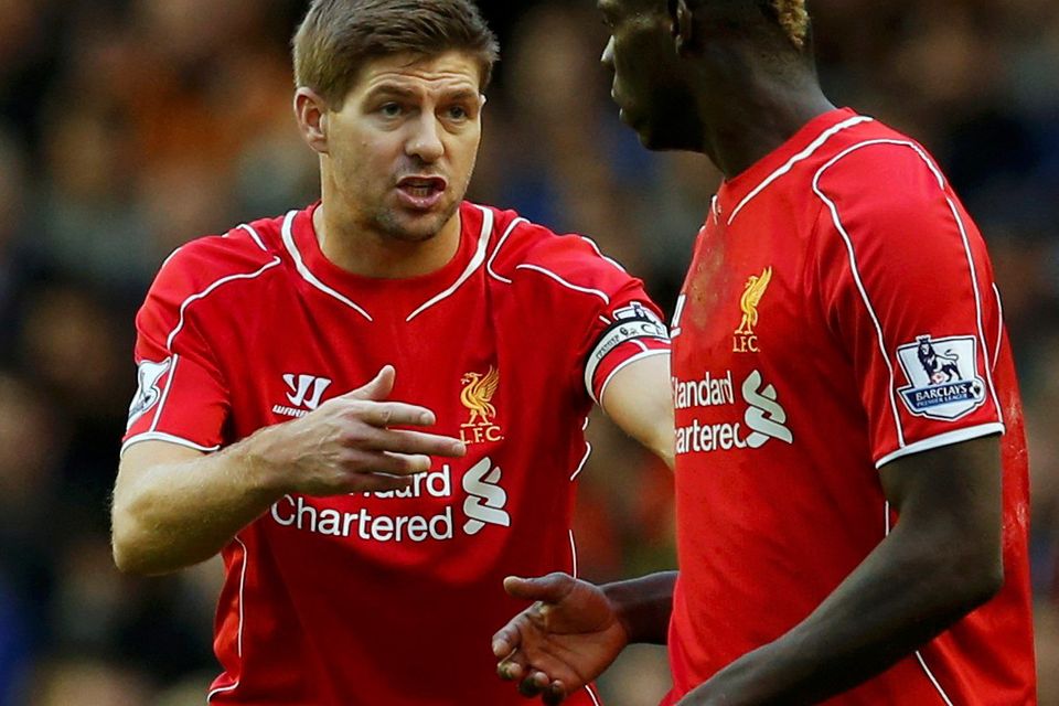 Liverpool captain Steven Gerrard (L) speaks with teammate Mario Balotelli during their English Premier League soccer match against Hull City at Anfield in Liverpool, northern England October 25, 2014.