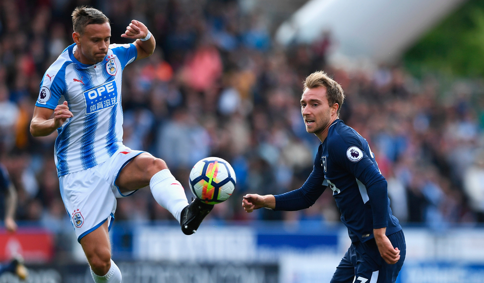 Chris Lowe of Huddersfield Town and Christian Eriksen of Tottenham Hotspur battle for possession. Photo: Getty Images