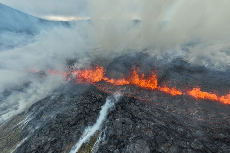 Smoke billows and lava spurts after the eruption of a volcano, on the Reykjanes peninsula. Photo: Juergen Merz via Reuters