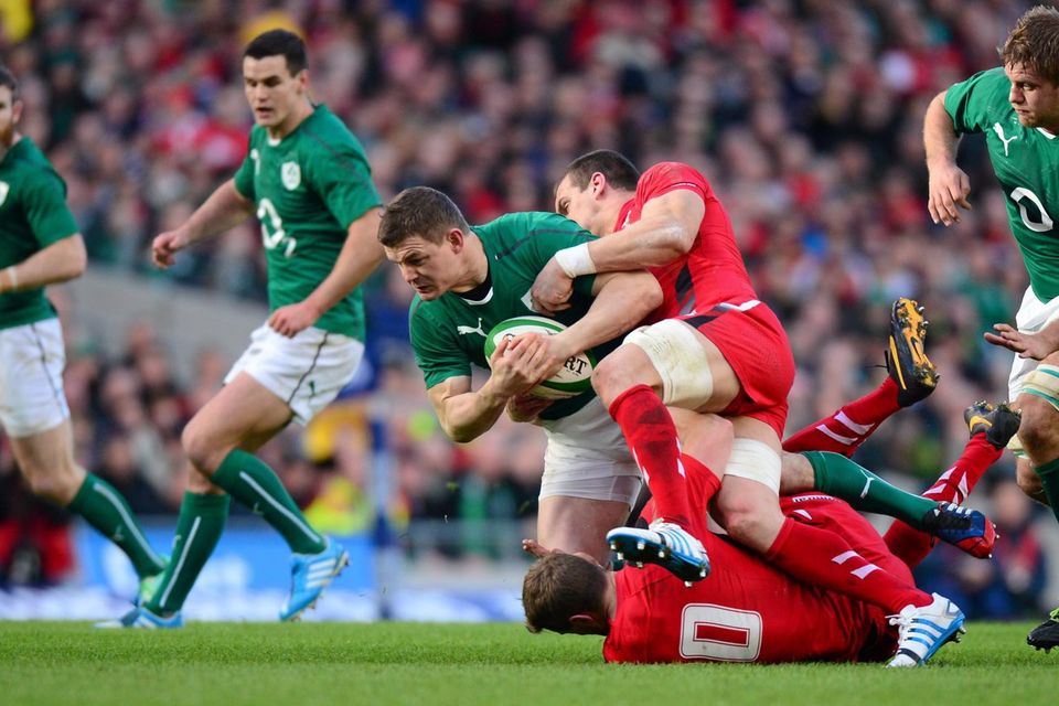 Brian O'Driscoll is tackled by Rhys Priestland and Jamie Roberts as Ireland powered to victory over wales at the Aviva Stadium