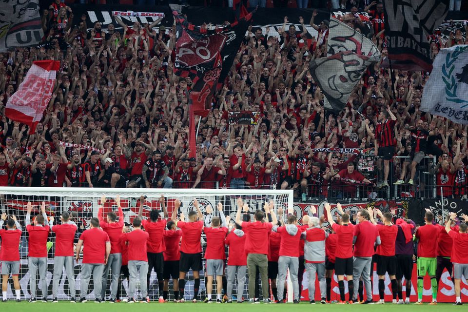 Bayer Leverkusen players and staff celebrate after beating Roma on aggregate to reach the Europa League final in Dublin on May 22
