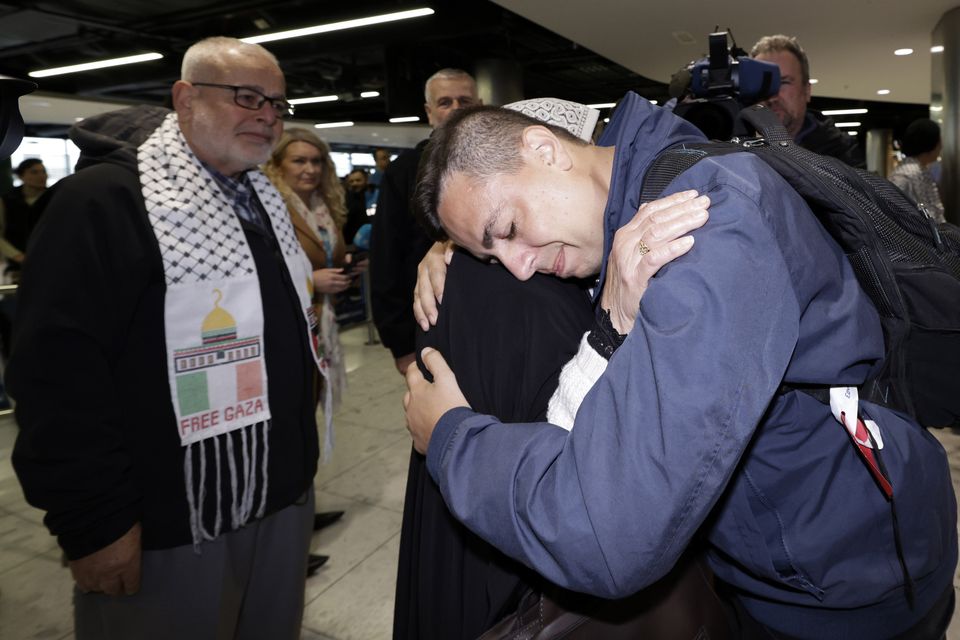  Ibrahim Alagha hugs his mother Marwa  at Dublin airport, watched by his father Dr. Sami Alagha. PIC: Conor Ó Mearáin / Collins Photo Agency