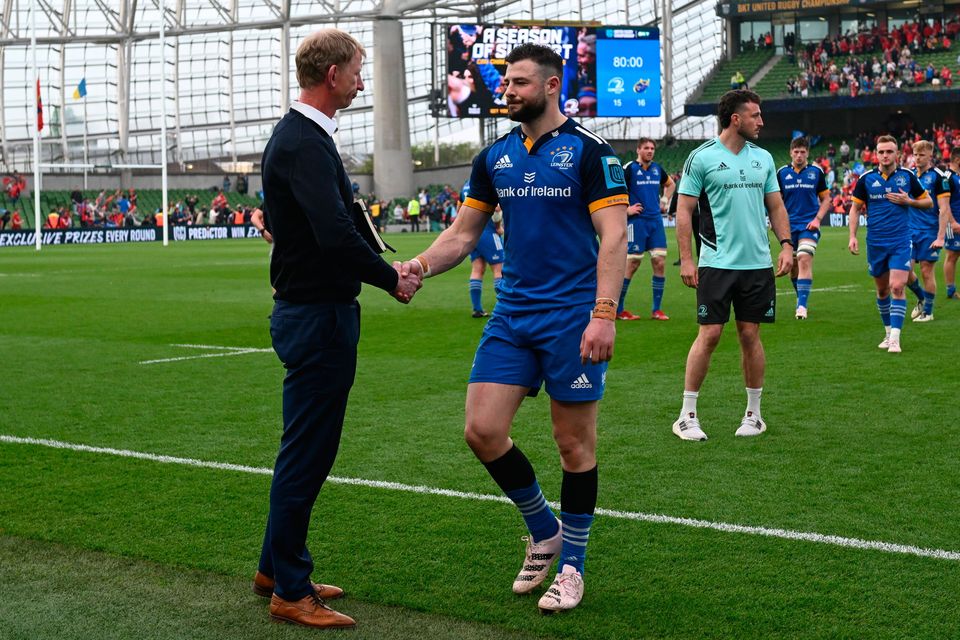 Leinster head coach Leo Cullen commiserates with Robbie Henshaw after the United Rugby Championship semi-final defeat to Munster at the Aviva Stadium