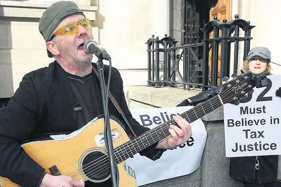 A Bono impersonator outside the Department of Finance in Dublin to highlight a campaign for 'global tax justice'. Campaigners claim
millions of euros are lost from impoverished countries each year due to tax avoidance and tax evasion