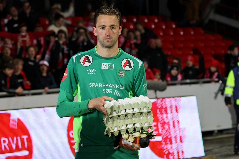 Bryne FK goalkeeper Jan De Boer holds eggs given out by the soccer club to the best player in a match, at Bryne Stadium in Bryne, Norway