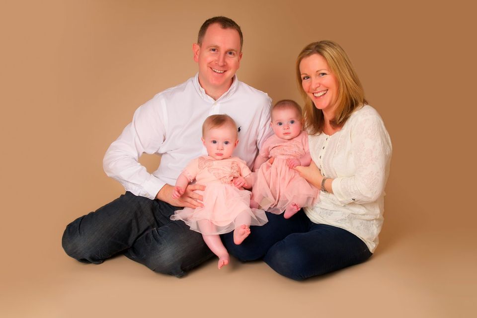 Alison pictured with her husband Neil and twins Meghan and Gemma, now 2