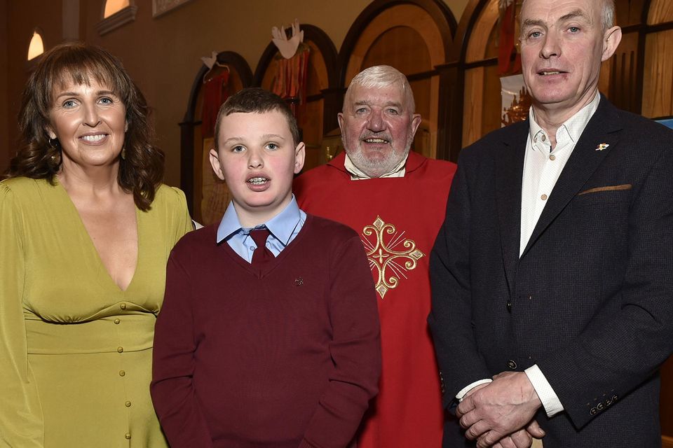 Daire Lancaster with Mary and Stephen Lancaster and the V Rev. Joseph Power PP.