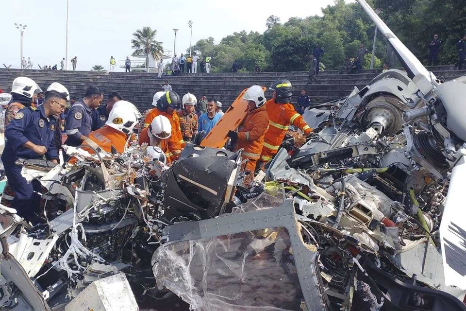 Malaysia’s navy says two military helicopters collided and crashed during a training session, killing all 10 people on board (Terence Tan/Ministry of Communications and Information via AP)