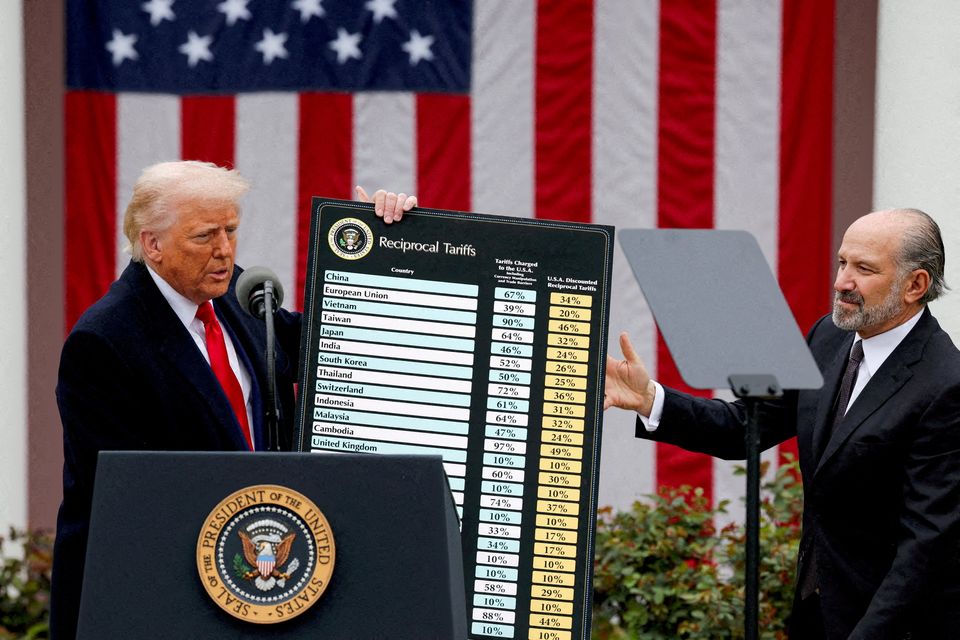 US president Donald Trump holds a tariffs chart next to commerce secretary Howard Lutnick at the White House. Photo: Reuters