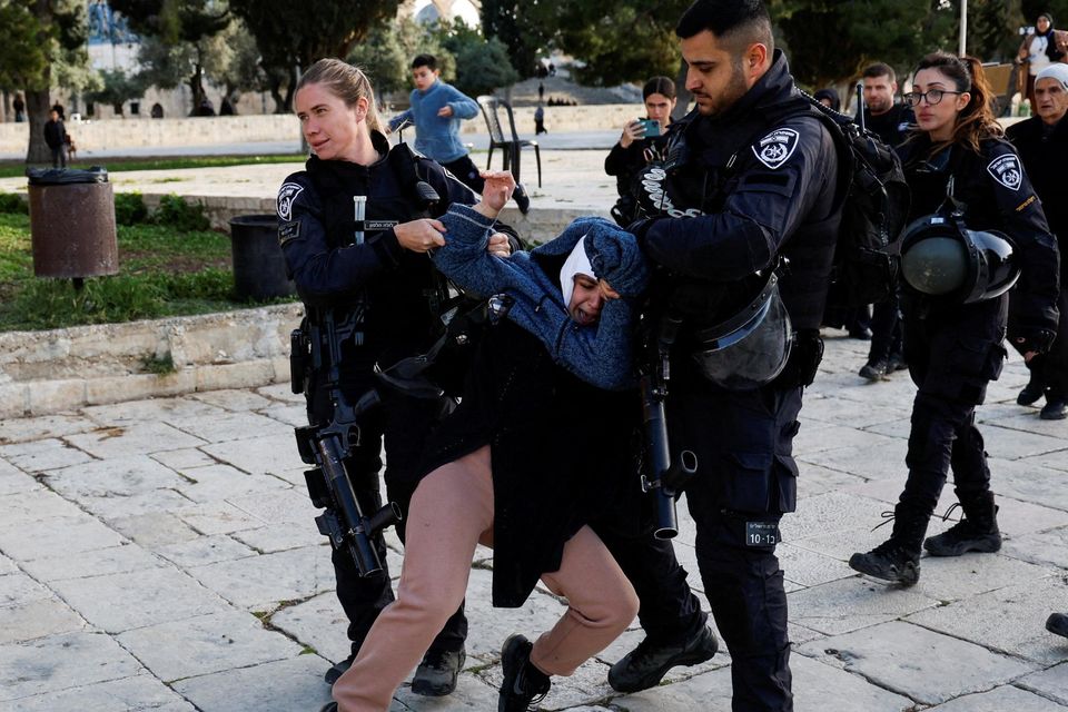 Israeli border police detain a Palestinian woman at the Al-Aqsa compound. Photo: Ammar Awad/Reuters