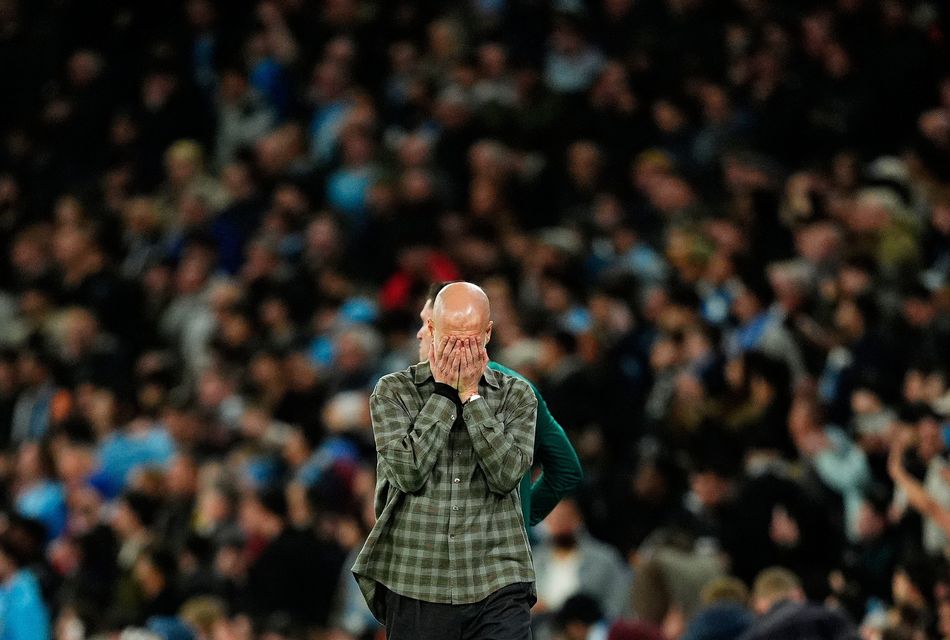 Manchester City manager Pep Guardiola holds his head in his hands. Photo: PA
