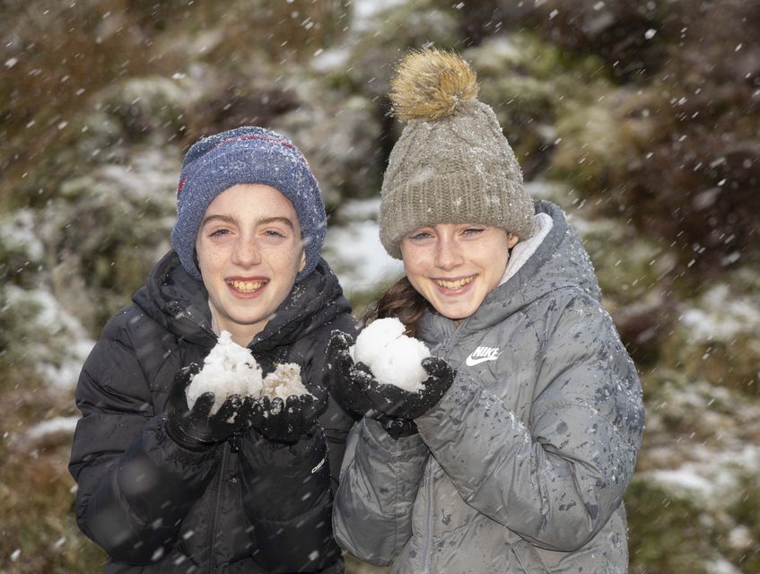 Brian and Ellen Kelleher enjoy the blizzard conditions at Mahon Falls in the Comeragh Mountains, Co Waterford. Photo: Patrick Browne