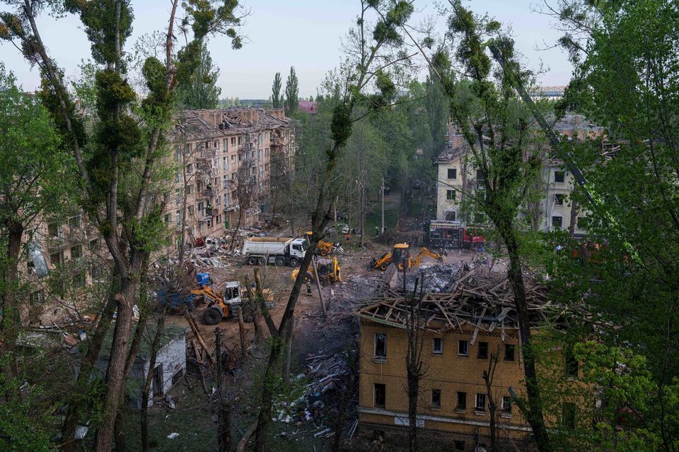Rescue workers clear the rubble of after a Russian strike on homes in Kyiv last Thursday. Photo: AP