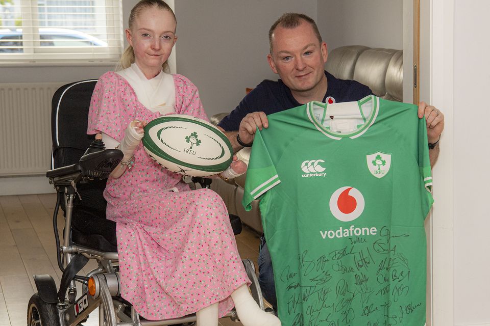 Claudia Scanlon and Dave Doyle with a signed rugby jersey being raffled to raise funds for charity Debra