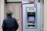 thumbnail: A local passerby takes a closer look at the scene of the ATM foiled raid on the Main Street in Virginia, Co Cavan.
Pic Steve Humphreys
