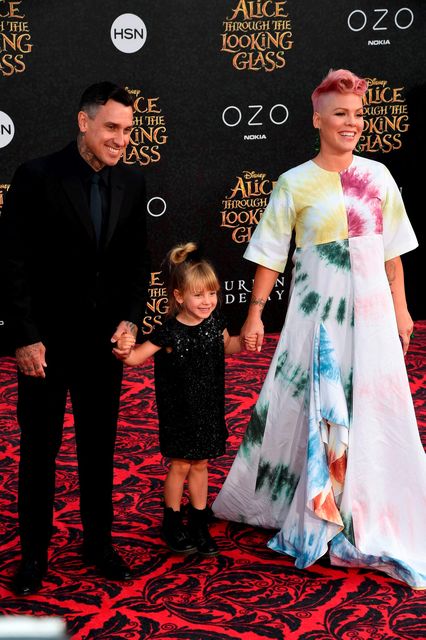 Singer-songwriter Pink attends the premiere of Disney's 'Alice Through The Looking Glass" with her husband Carey Hart (L) and daughter Willow Sage Hart, May 23, 2106 at the El Capitan Theatre