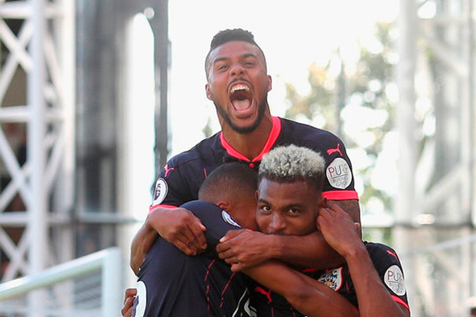 Steve Mounie of Huddersfield Town celebrates scoring his sides third goal with teammates   Photo: Getty