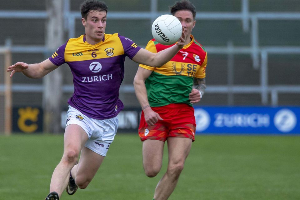 Wexford centre-back Páraic Hughes on the move away from Carlow’s Shane Clarke.