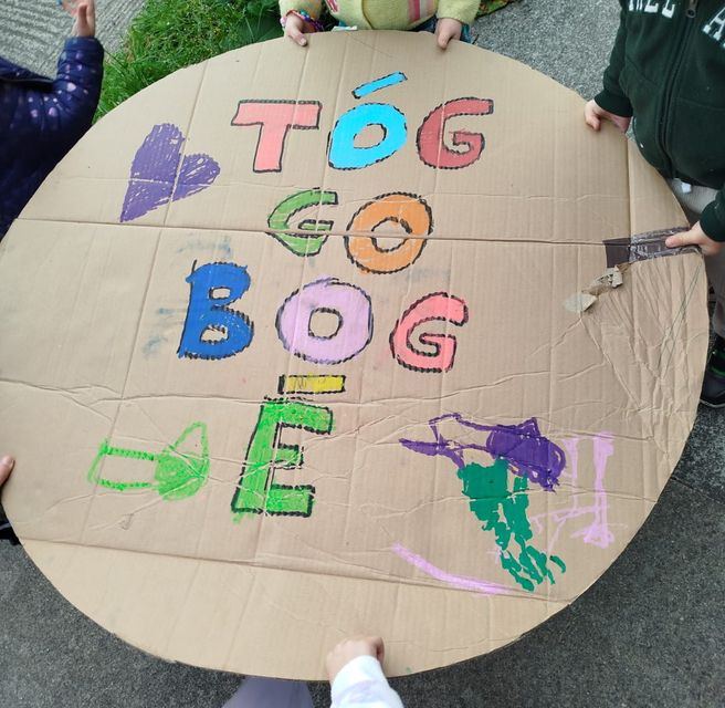 A sign created by local children appealing to drivers to 'Tóg go bog é' (take it easy)