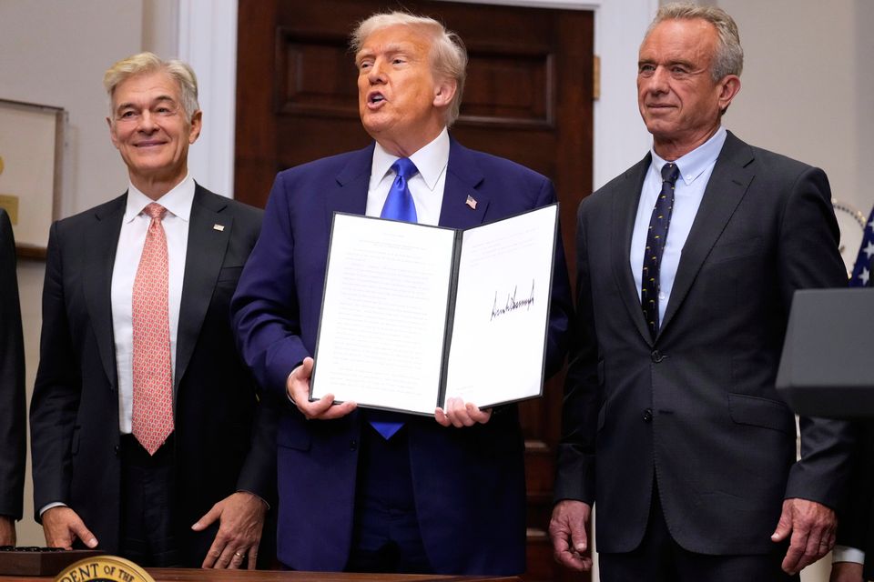 US president Donald Trump holds an executive order related to drug prices alongside Dr Mehmet Oz, administrator of the Centres for Medicare & Medicaid Services (left), and health and human services secretary Robert F Kennedy Jr (right) in the White House on Monday. Photo: AP