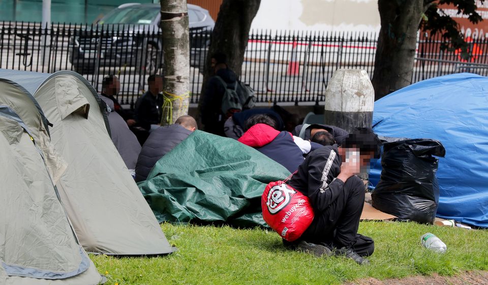 Migrants pictured in the camp along the Grand Canal.  Photo: Gerry Mooney