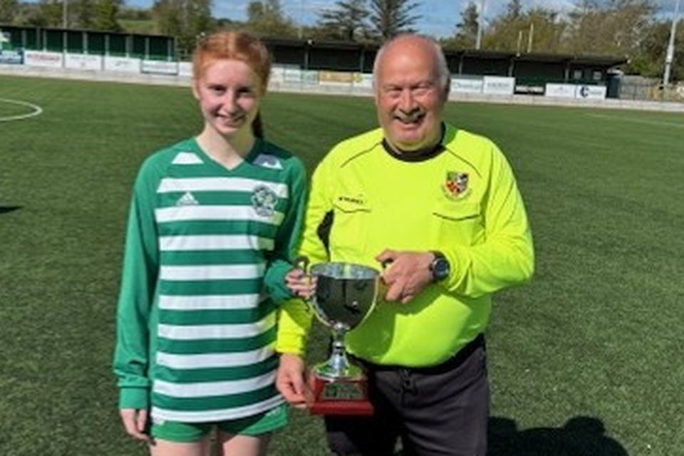 Tom O'Sullivan presenting the cup to Killarney Celtic captain Clodagh Moriarty after her team won the Girls Under-17 Cup final