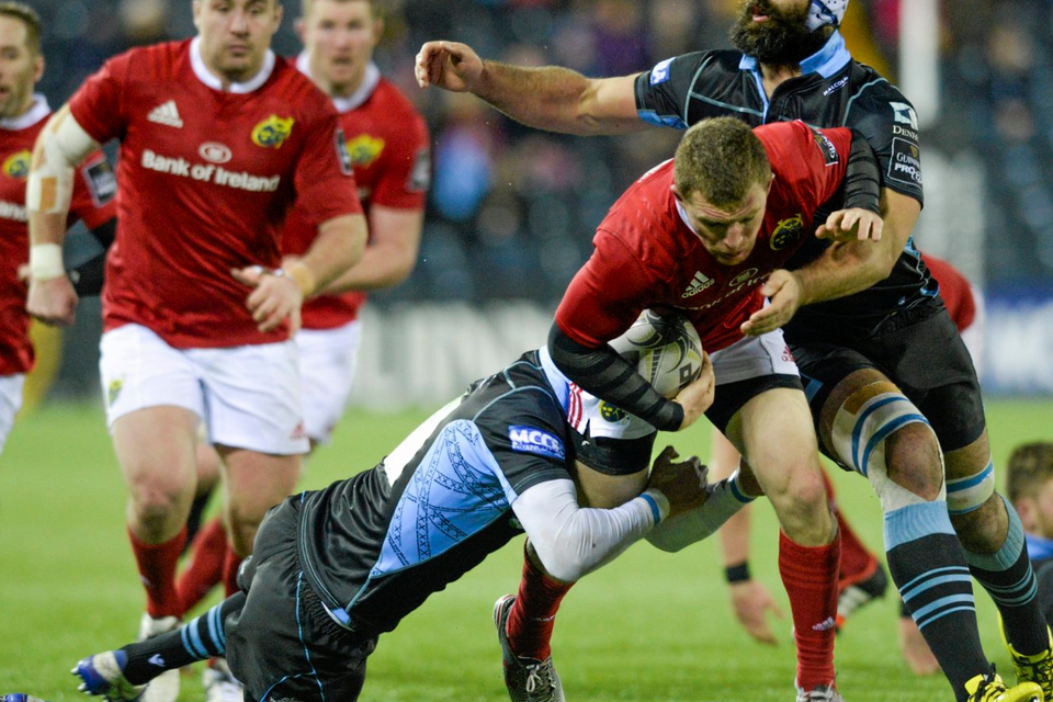 Andrew Conway is tackled by Peter Murchie, left, and, Josh Strauss (SPORTSFILE)