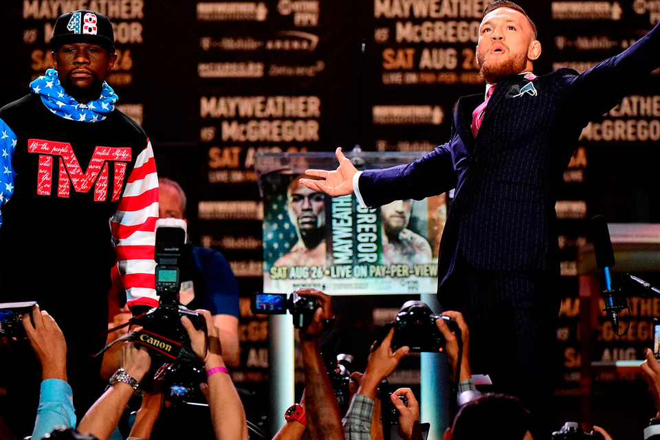 Floyd Mayweather and Conor McGregor faceoff on stage at the Staples Center, Los Angeles last night. Photo: Getty Images