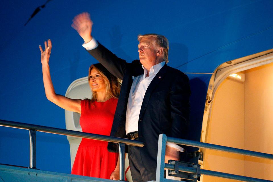 U.S. President Donald Trump and first lady Melania Trump wave from Air Force One after a "Make America Great Again" rally at Orlando Melbourne International Airport in Melbourne, Florida, U.S. February 18, 2017.  REUTERS/Kevin Lamarque