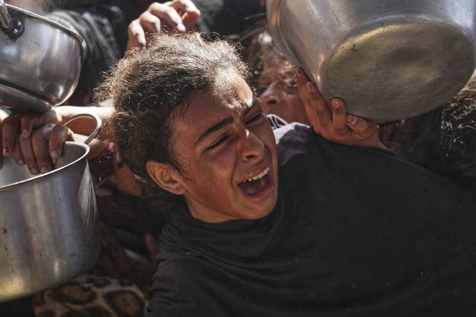 Palestinians are struggling to obtain food as the conflict goes on (AP)