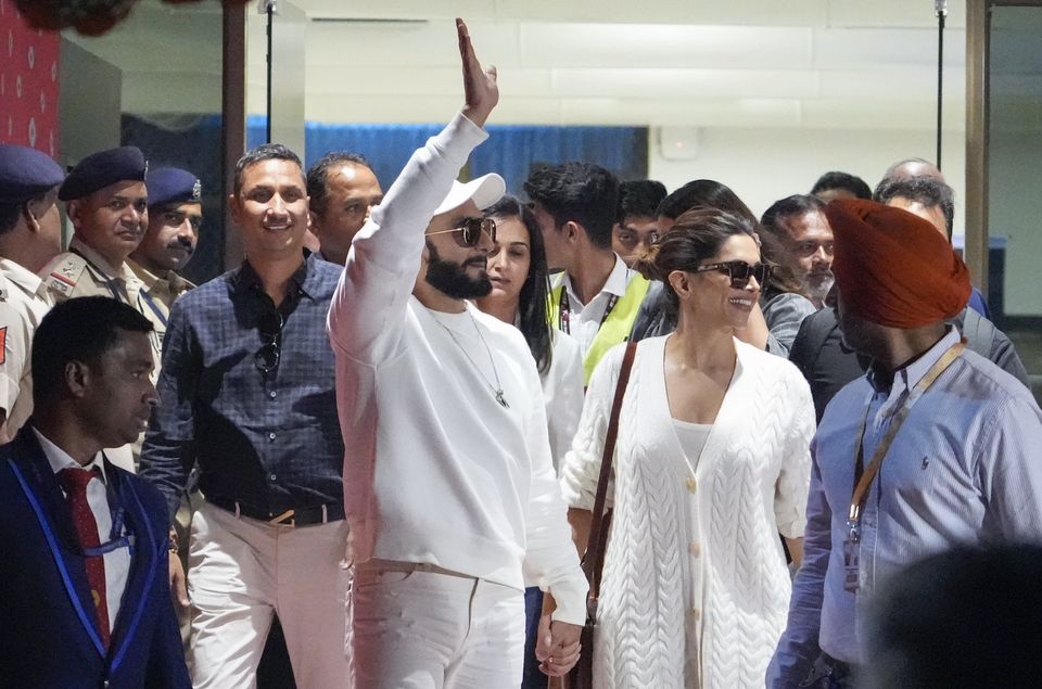 Bollywood actors Ranveer Singh, left, and Deepika Padukone arrive at an airport in Jamnagar, India, to attend the pre-wedding celebrations of Anant Ambani and Radhika Merchant (Ajit Solanki/AP)