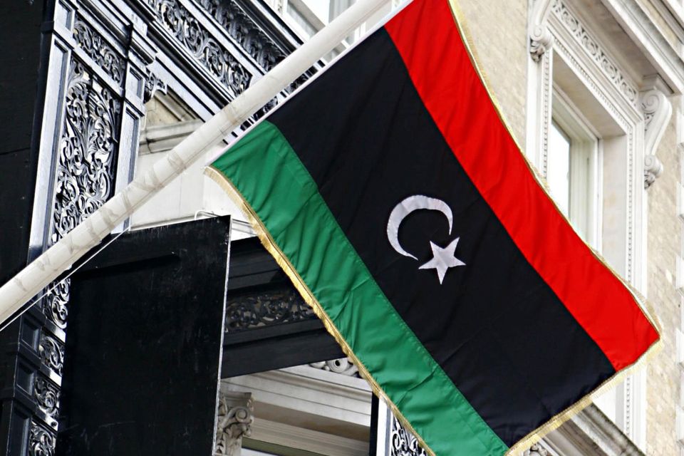 The flag of the Libyan Republic used by the National Transitional Council outside the Libyan Embassy in London.