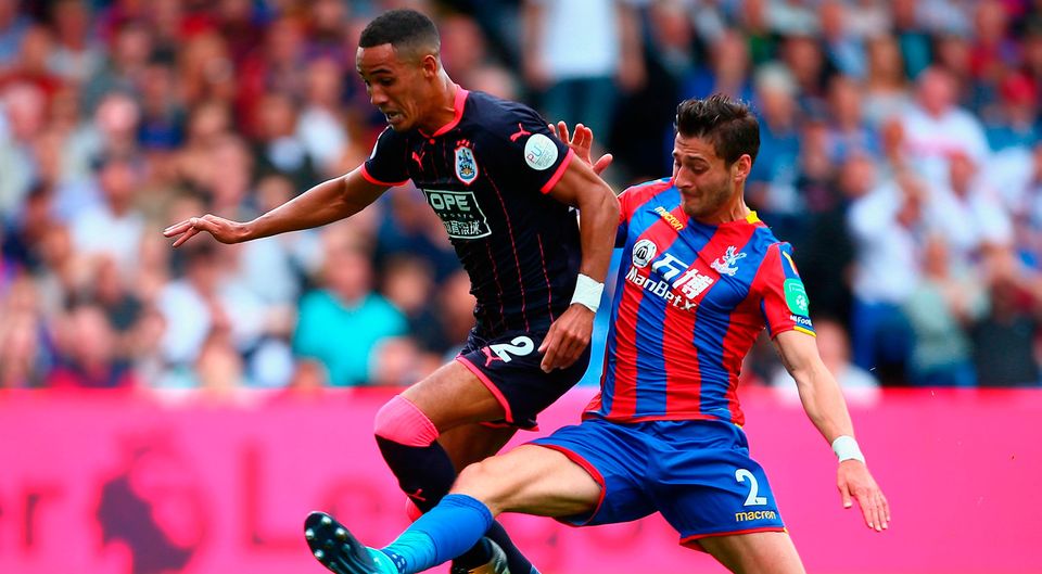 Joel Ward of Crystal Palace tackles Tom Ince of Huddersfield Town   Photo: Getty