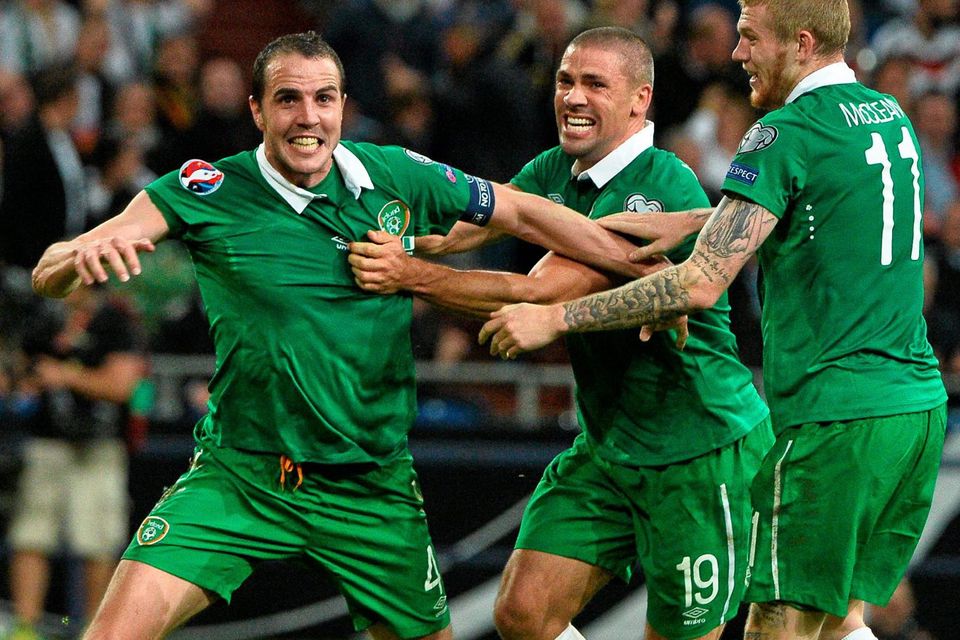 John O'Shea, left, celebrates after scoring his side's equalizing goal with team-mates Jonathan Walters, centre, and James McClean