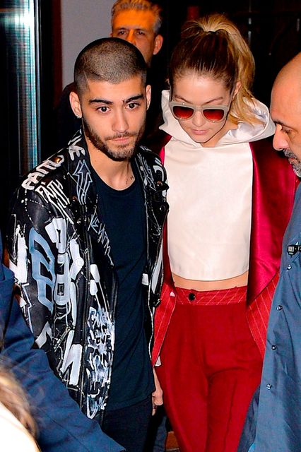 Zayn Malik and girlfriend supermodel Gigi Hadid help a fan that fainted after seeing the couple leaving their East Village apartment on March 25, 2016 in New York City. (PH๏τo by Robert Kamau/GC Images)