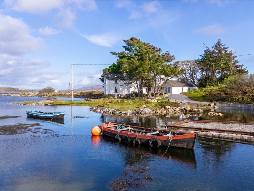 Cannute House is accessed by a winding waterside road, or by boat from the adjacent Canower Pier 