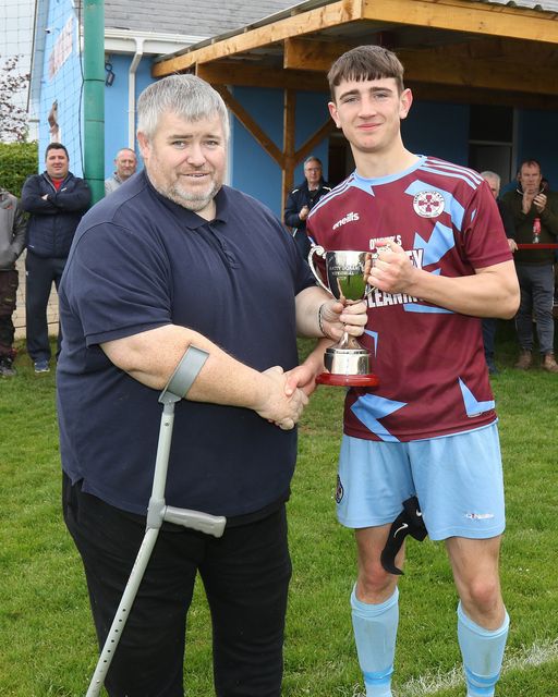 Phillip O'Brien presenting the Youths Division 2 cup to Ferns United captain Ben O'Connor.