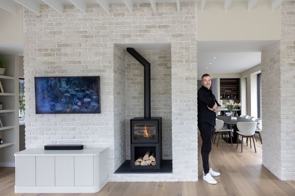 Marketing entrepreneur Jonny Davis in the living area of ​​the split-plan kitchen-diner of his new home in Co Wicklow.  The opening on the left leads into the kitchen while the space it is in opens into the dining room.  The floor is in laminated oak while the masonry is in Casa Lena bricks.  “We are full of admiration for everyone who worked on the house.  Such talent, such know-how, such good people.  We feel so lucky, we pinch ourselves a lot." Photo: Tony Gavin