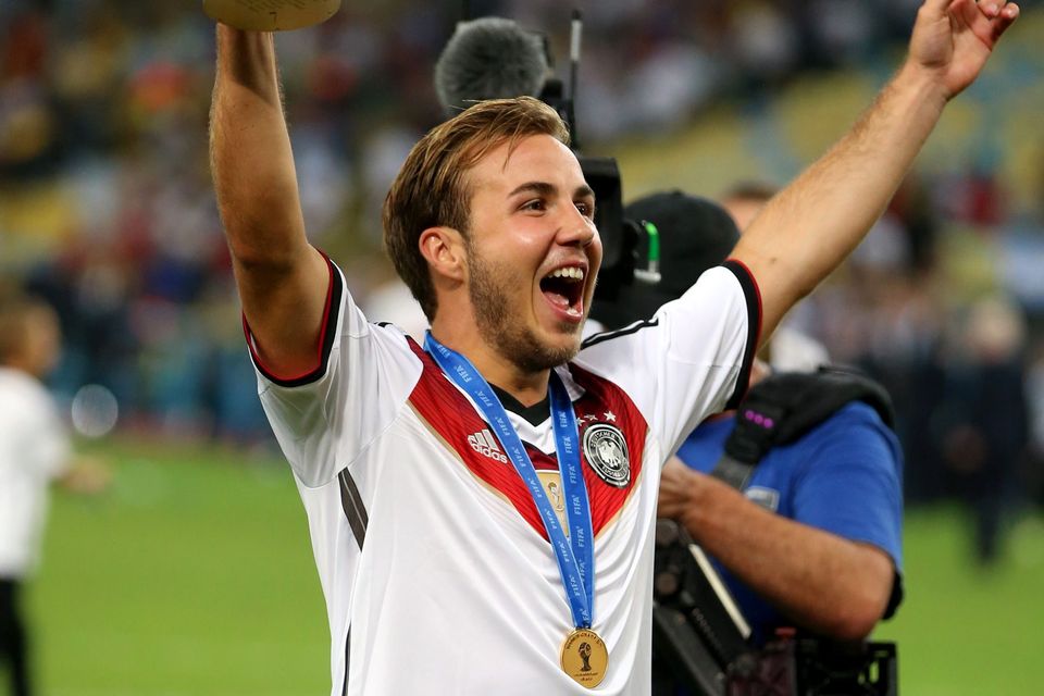 Philipp Lahm of Germany lifts the World Cup trophy to celebrate